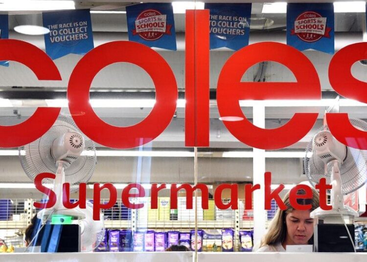 A woman is seen shopping at a Coles supermarket in the central business district of Sydney on March 16, 2018. - Australian supermarket chain Coles will be spun off into a separate entity by owner Wesfarmers, the company said on March 16, amid a shake-up in the food retail sector as new entrants threaten a longstanding duopoly. (Photo by William WEST / AFP)