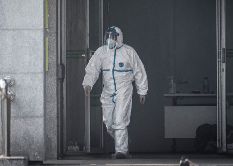 A medical staff member walks outside the Jinyintan hospital, where patients infected by a mysterious SARS-like virus are being treated, in Wuhan in China's central Hubei province on January 18, 2020. - The true scale of the outbreak of a mysterious SARS-like virus in China is likely far bigger than officially reported, scientists have warned, as countries ramp up measures to prevent the disease from spreading. (Photo by STR / AFP) / China OUT