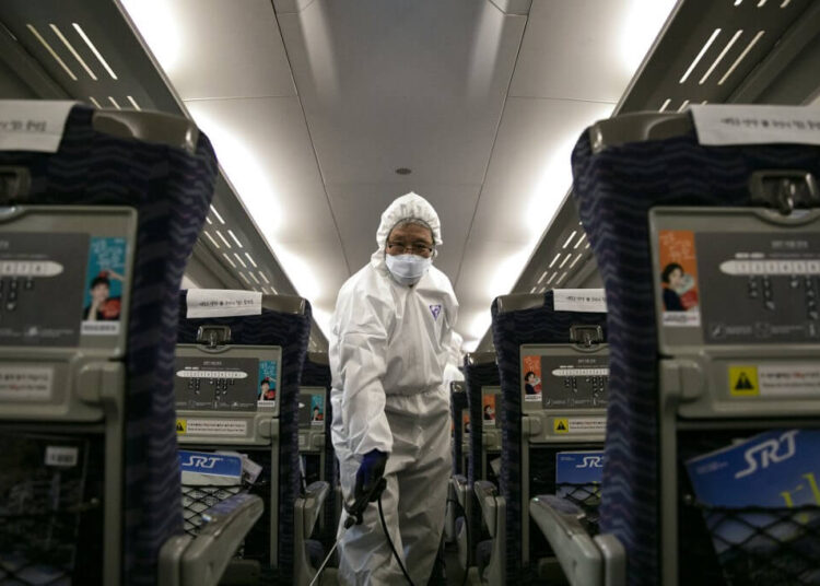 A worker from a cleaning and disinfection service sprays disinfectant in a train as part of efforts to prevent the spread of a new virus which originated in the Chinese city of Wuhan at Suseo railway station in Seoul on January 24, 2020. - South Korea on January 24 confirmed its second case of the SARS-like virus that has killed at least 26 in China, as concerns mount about a wider outbreak. (Photo by Hong Yoon-gi / AFP)