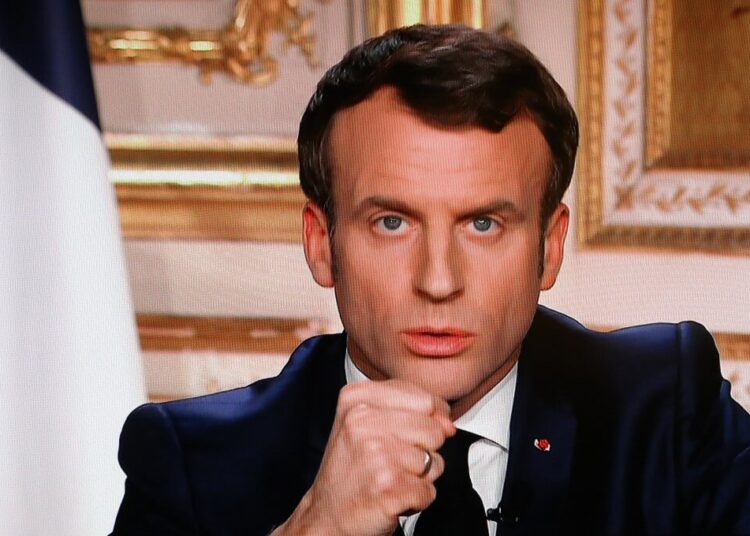 French President Emmanuel Macron is seen on a television screen as he speaks during a televised address to the nation on the outbreak of COVID-19, caused by the novel coronavirus, on March 16, 2020, in Paris. - The French president addresses the nation, with many expecting him to unveil more strict home confinement rules in a bid to prevent the virus from spreading. France has closed down all schools, theatres, cinemas and a range of shops, with only those selling food and other essential items allowed to remain open. The balance sheet of the epidemic climbed to 127 dead and 5,423 confirmed cases in France. (Photo by Ludovic Marin / AFP)