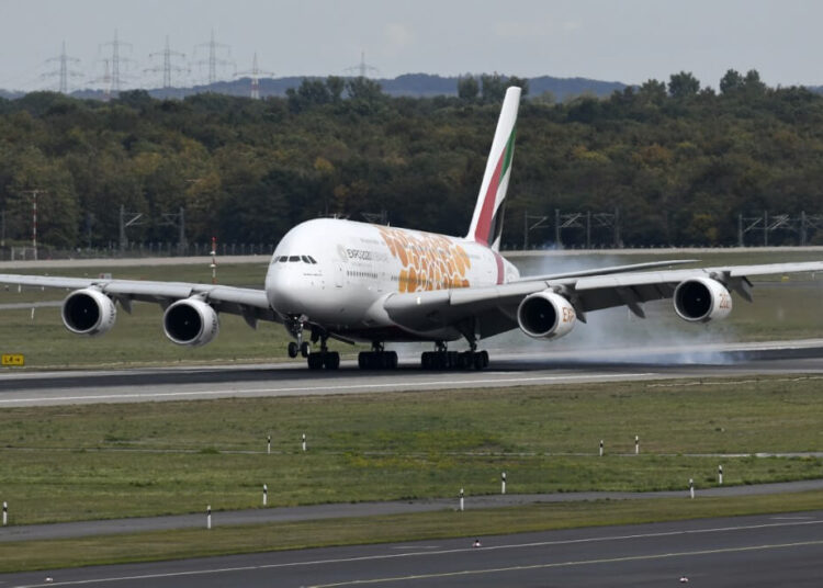 (FILES) A photo taken on September 24, 2019 shows an Airbus A380 of the Emirates airline during landing at the airport in Duesseldorf, western Germany. - Dubai carrier Emirates reversed its decision to suspend all passenger flights shortly after it said would halt operations from March 25 amid the novel coronavirus outbreak. The announcement was made just a few hours after a previous statement said the carrier "will have temporarily suspended all its passenger operations" by March 25. (Photo by Ina FASSBENDER / AFP)