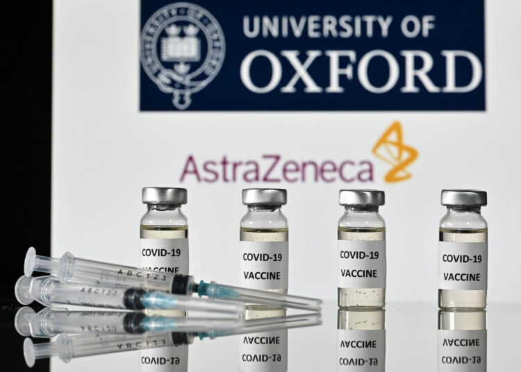 (FILES) In this file photo taken on November 17, 2020 An illustration picture shows vials with Covid-19 Vaccine stickers attached and syringes, with the logo of the University of Oxford and its partner British pharmaceutical company AstraZeneca. Drugs company AstraZeneca and British Prime Minister Boris Johnson on January 28, 2021 defended the effectiveness of its Covid-19 vaccine after regulators in Germany said it should not be given to over 65s. (Photo by JUSTIN TALLIS / AFP)
