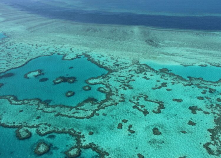 (FILES) This photo taken on November 20, 2014 shows an aerial view of the Great Barrier Reef off the coast of the Whitsunday Islands, along the central coast of Queensland. - Australia will strongly oppose a UNESCO plan to list the Great Barrier Reef as "in danger" over its deterioration caused by climate change, the government said on June 22, 2021. (Photo by SARAH LAI / AFP)