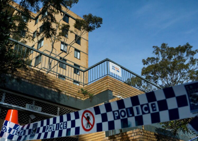 Police tape restricts the entrance to a Sydney apartment block after it was placed under strict lockdown, with residents barred from leaving, in the Bondi neighbourhood of Sydney on July 13, 2021, as authorities stepped up efforts to curb a fast-growing coronavirus outbreak. (Photo by Andrew LEESON / AFP)