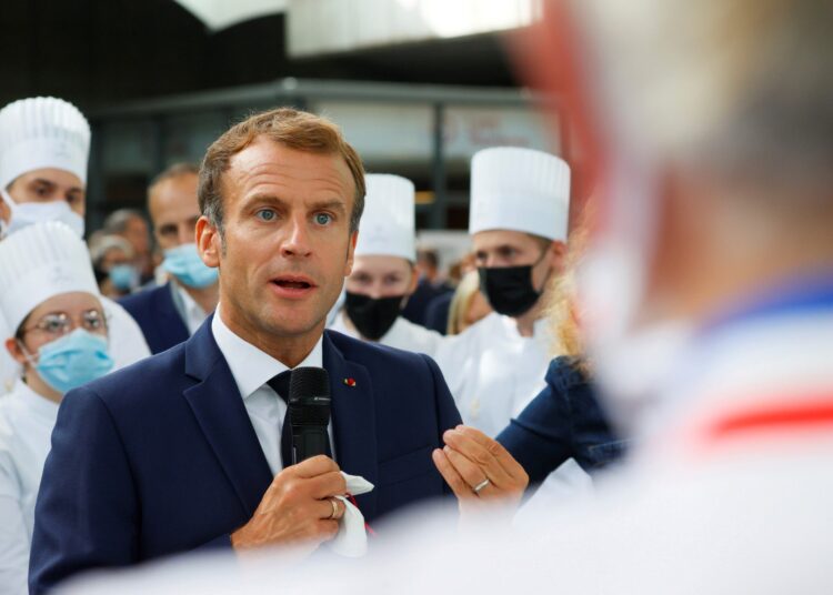 French President Emmanuel Macron speaks to attendees during his visit to the International Catering, Hotel and Food Trade Fair (SIRHA - salon international de la restauration, de l'hotellerie et de l'alimentation) at the Eurexpo hall in Lyon, central eastern France, on September 27, 2021. (Photo by DENIS BALIBOUSE / POOL / AFP)