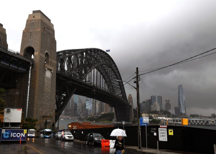 Storm clouds pass above Sydney Harbour on October 14, 2021. (Photo by Saeed KHAN / AFP)