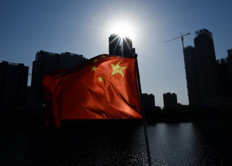 A Chinese national flag flutters on a boat in Beijing on October 29, 2019. (Photo by WANG Zhao / AFP)