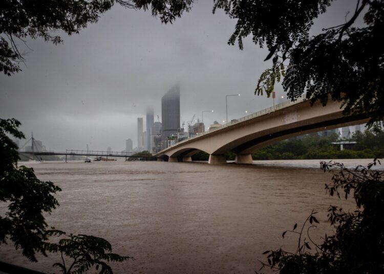 The overflowing Brisbane River is seen from South Bank, Australia's Queensland state on February 27, 2022. (Photo by Patrick HAMILTON / AFP)