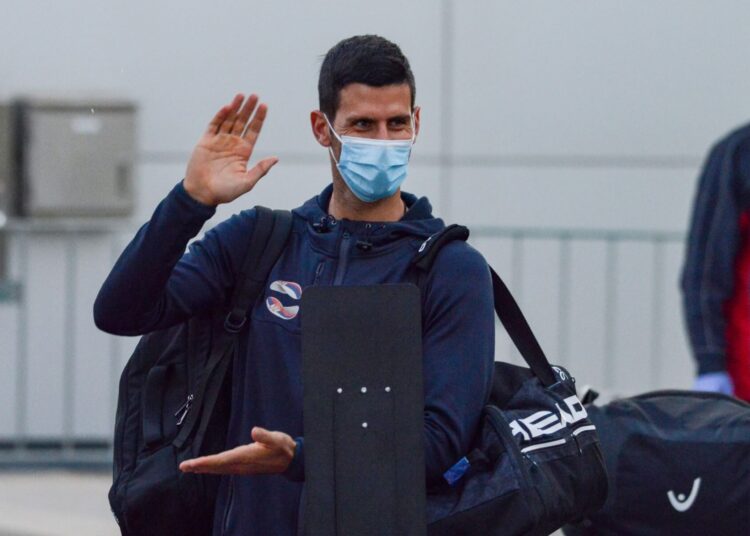 Serbian tennis player Novak Djokovic arrives before heading straight to quarantine for two weeks isolation ahead of their Australian Open warm up matches in Adelaide on January 14, 2021. (Photo by Brenton EDWARDS / AFP)