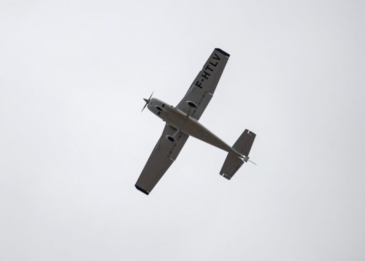 A photograph shows a F-HTLV Cessna 182T Skylane aircraft flying over the beach of Wimereux, north of France, to monitor migrants trying to cross the English Channel from France to Britain on March 16, 2022. (Photo by Sameer Al-DOUMY / AFP)