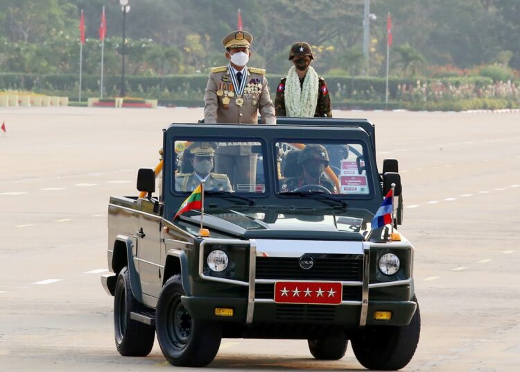Myanmar's Chief Senior General Min Aung Hlaing (L) attends a ceremony to mark the country's 77th Armed Forces Day in Naypyidaw on March 27, 2022. (Photo by STR / AFP)