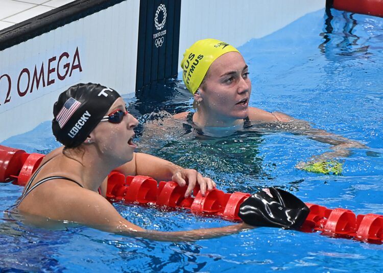 Australia's Ariarne Titmus (R) reacts next to USA's Kathleen Ledecky after winning the final of the women's 200m freestyle swimming event and setting an Olympic Record during the Tokyo 2020 Olympic Games at the Tokyo Aquatics Centre in Tokyo on July 28, 2021. (Photo by Attila KISBENEDEK / AFP)