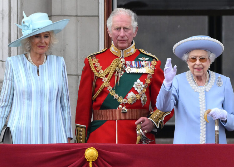 Britain's Queen Elizabeth II (R) stands with Britain's Camilla, Duchess of Cornwall (L) and Britain's Prince Charles, Prince of Wales to watch a special flypast from Buckingham Palace balcony following the Queen's Birthday Parade, the Trooping the Colour, as part of Queen Elizabeth II's platinum jubilee celebrations, in London on June 2, 2022. - Huge crowds converged on central London in bright sunshine on Thursday for the start of four days of public events to mark Queen Elizabeth II's historic Platinum Jubilee, in what could be the last major public event of her long reign. (Photo by Daniel LEAL / AFP)
