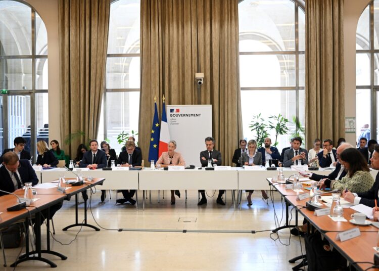 French Prime Minister Elisabeth Borne (C) and her Ministers Clement Beaune, Marc Fesneau, Agnes Pannier-Runacher, Gabriel Attal and Christophe Bechu meet with members of the National Council for Ecological Transition (Conseil National de la Transition Ecologique - CNTE) in Paris on May 22, 2023. (Photo by bERTRAND GUAY / AFP)