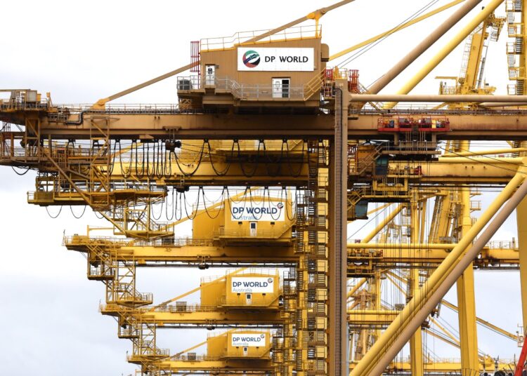 Gantry cranes adorned with logos for ports operator DP World is seen at Port Botany in Sydney on November 13, 2023. - Major ports handling nearly 40 percent of Australia's freight trade may be crippled for days, officials said on November 13, three days after a cyber attack blocked the key gateways. (Photo by DAVID GRAY / AFP)